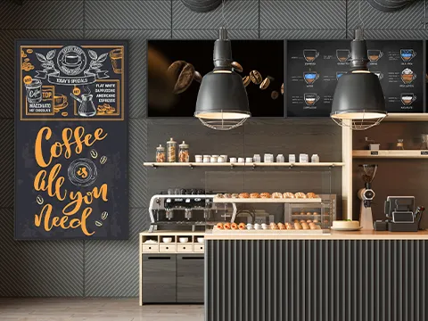 a cafe with a large format screen on the wall used for the menu