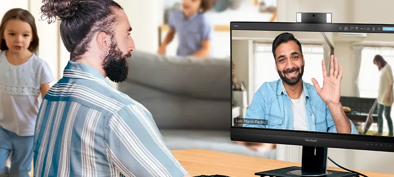 two people on a video call through the use of video conferencing monitors with built-in webcams